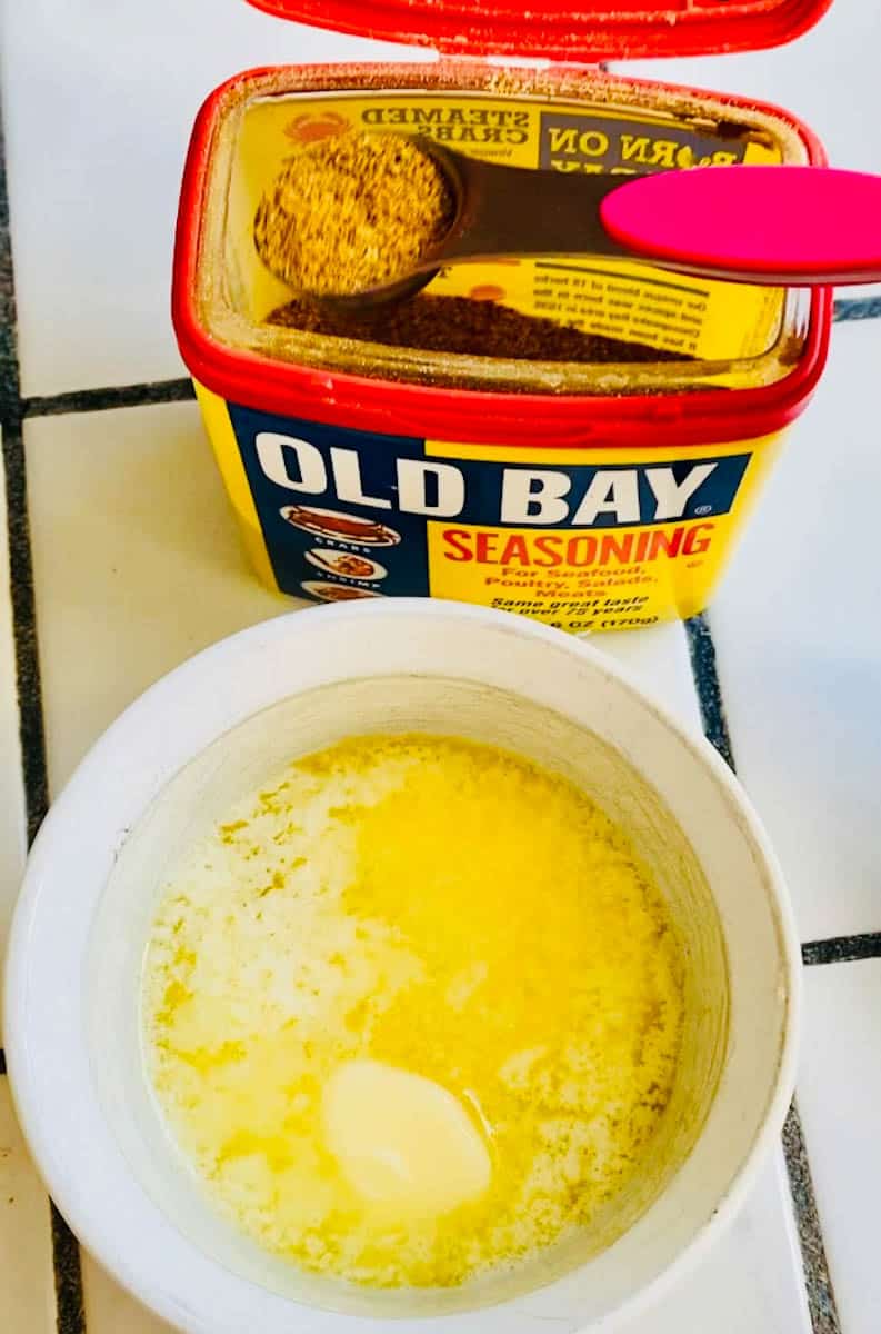 Teaspoon of Old Bay seasoning and a ramekin of melted butter.