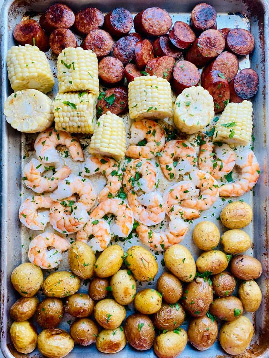 Sheet Pan Shrimp Boil means andouille sausage, corn, shrimp, and baby potatoes.