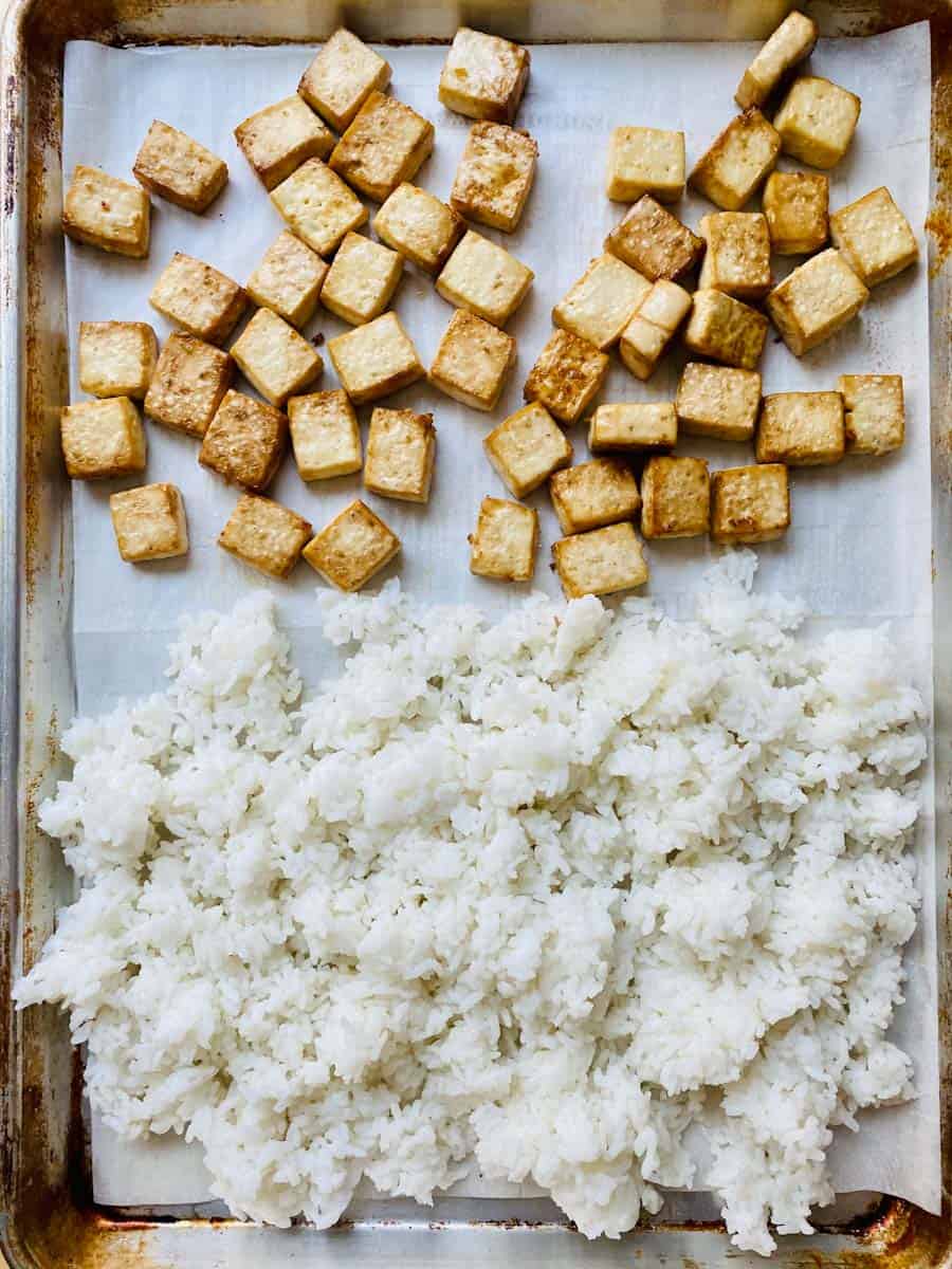 Tofu cubes and rice on a sheet pan.