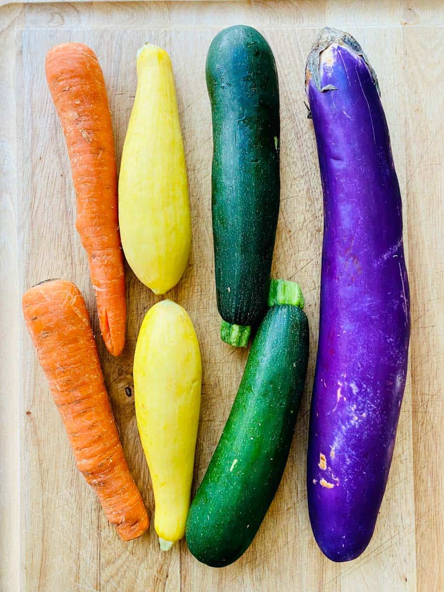 Carrots, yellow squash, zucchini, and eggplant lineup.
