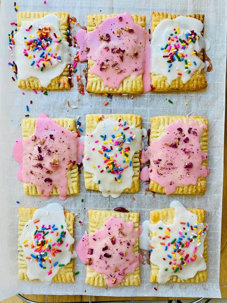 Homemade Pop Tarts sitting pretty on parchment paper.