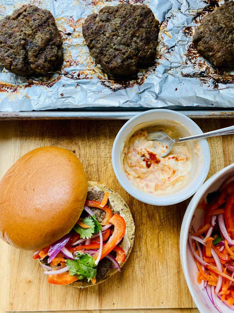 Putting it all together: burger, bun, slaw, and sauce.