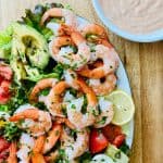 Shrimp Louie salad with dressing on the side.