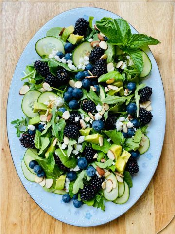 Arugula salad with avocado and berries.