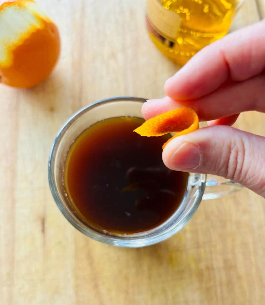 Orange peel expressed over the drink.