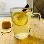 Hot toddy with cinnamon and lemon slice.