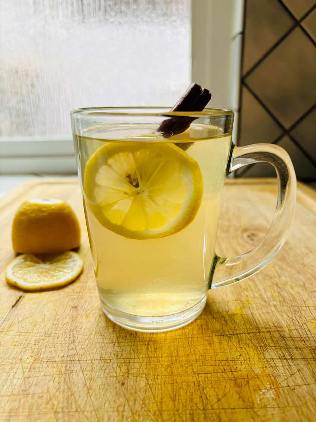Hot toddy with cinnamon and lemon slice.