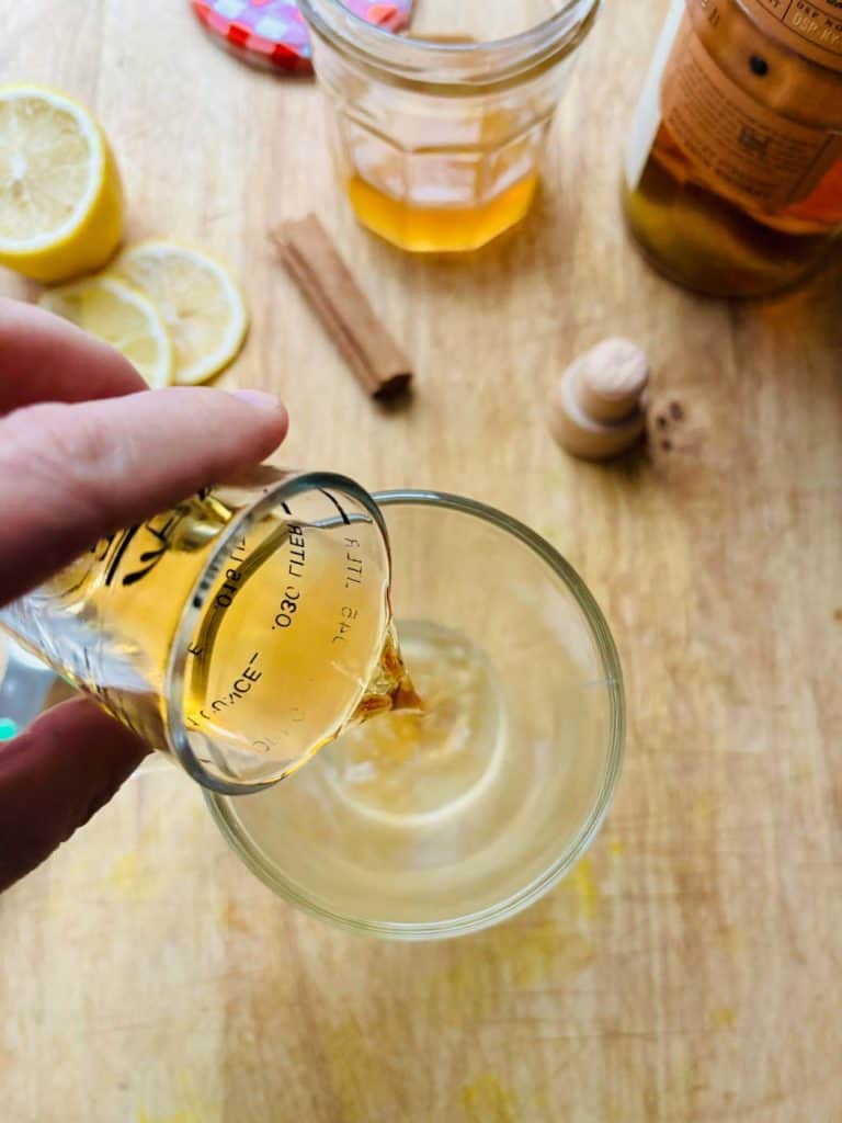 Pouring in the whiskey.