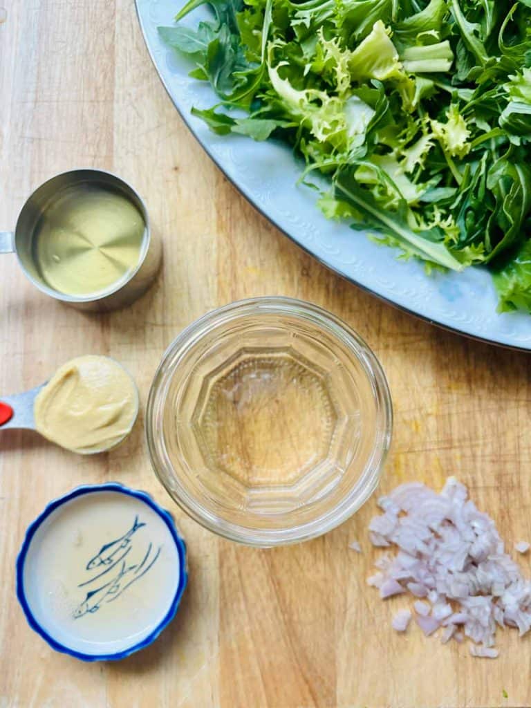 Olive oil, Dijon mustard, white wine vinegar, and chopped shallots.