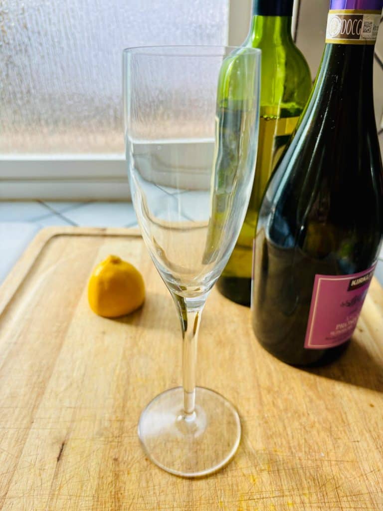Cut lemon, dry vermouth, and prosecco. Plus a flute.