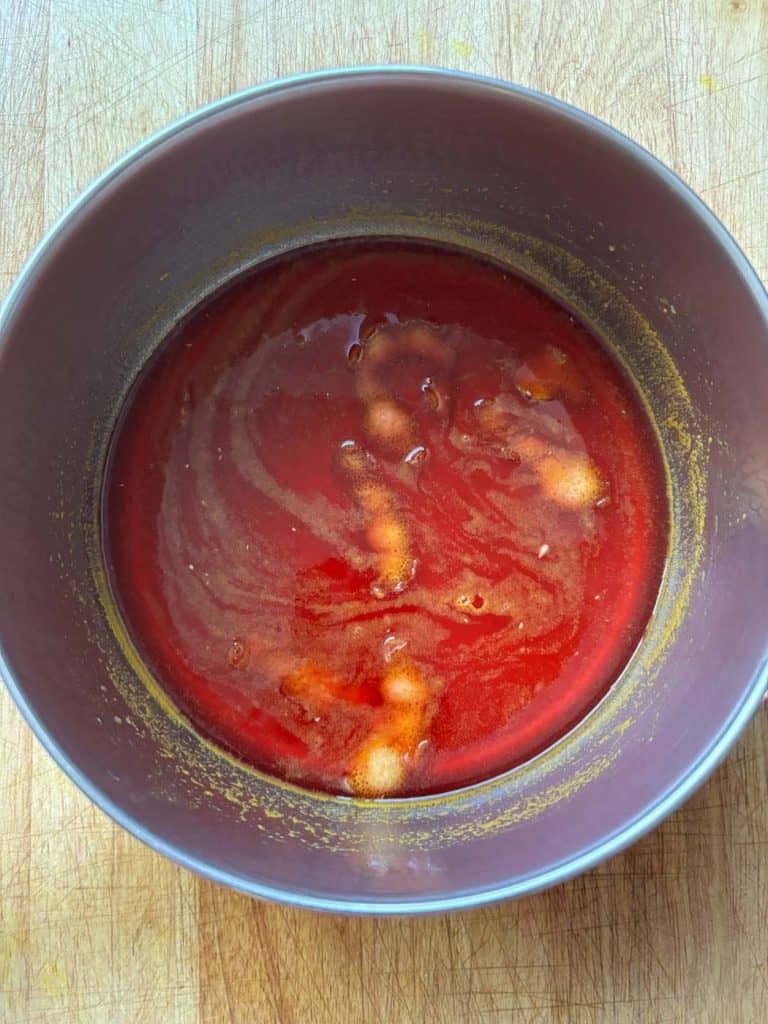 Blood orange juice, sweetener, and peel in a saucepan.