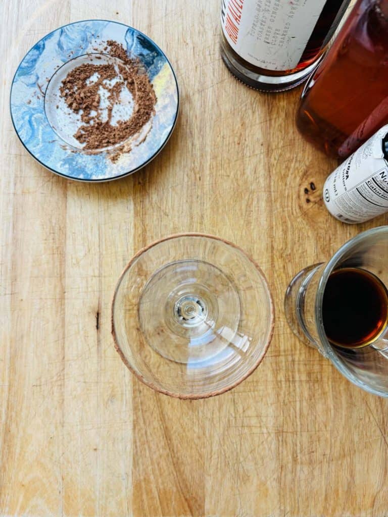 Cocoa powder, non-alcoholic rum, simple syrup, Angostura bitters, and espresso.