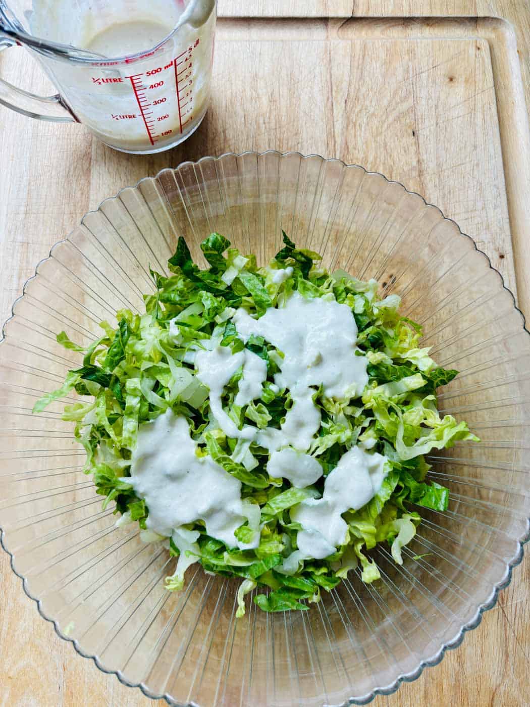 Caesar salad dressing on Romaine lettuce.