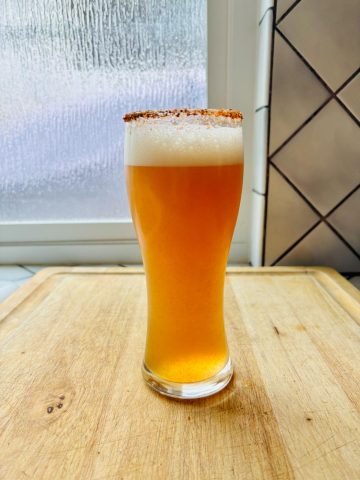 Michelada, Mexican beer cocktail in a glass.