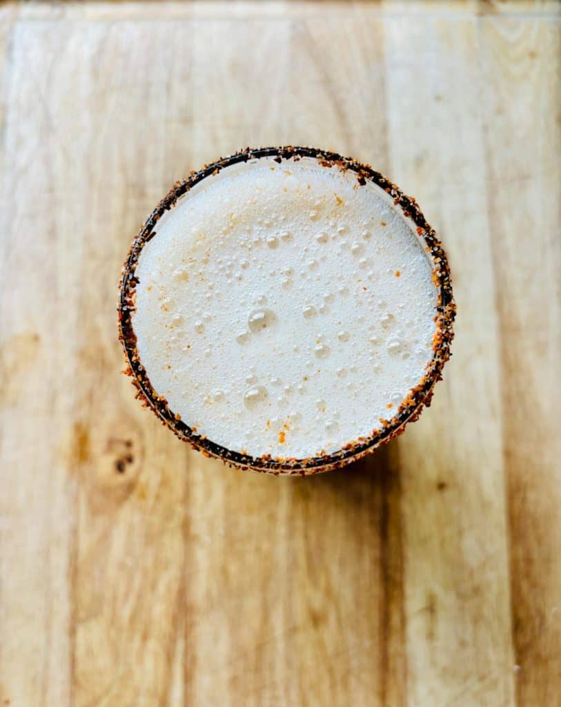 Overhead view of Michelada in a Tajin-rimmed glass.