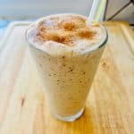 Date shake in a glass with a straw.