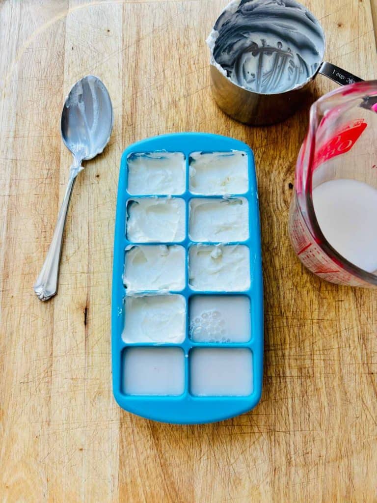 Greek yogurt and almond milk in an ice cube tray.