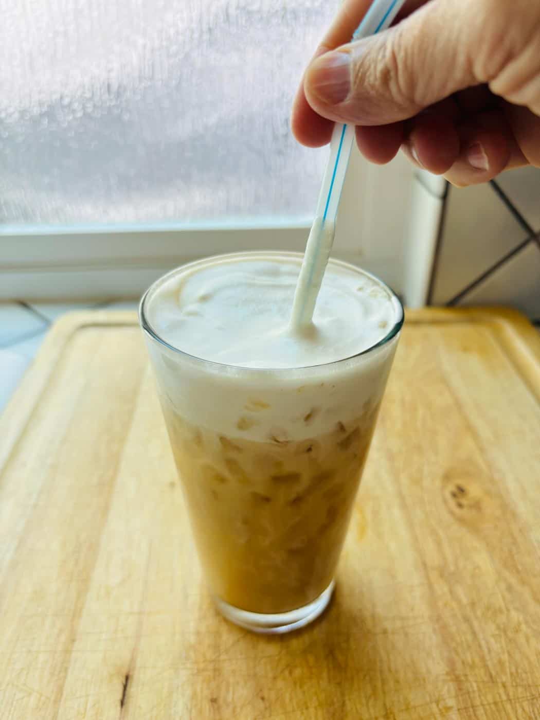 Stirring the iced London Fog.