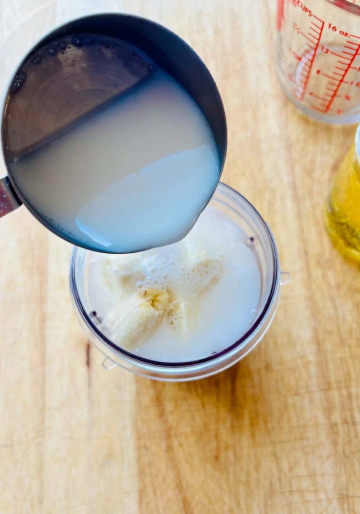 Pouring milk into blender.