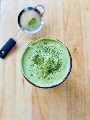Matcha cold foam dusted with matcha powder.