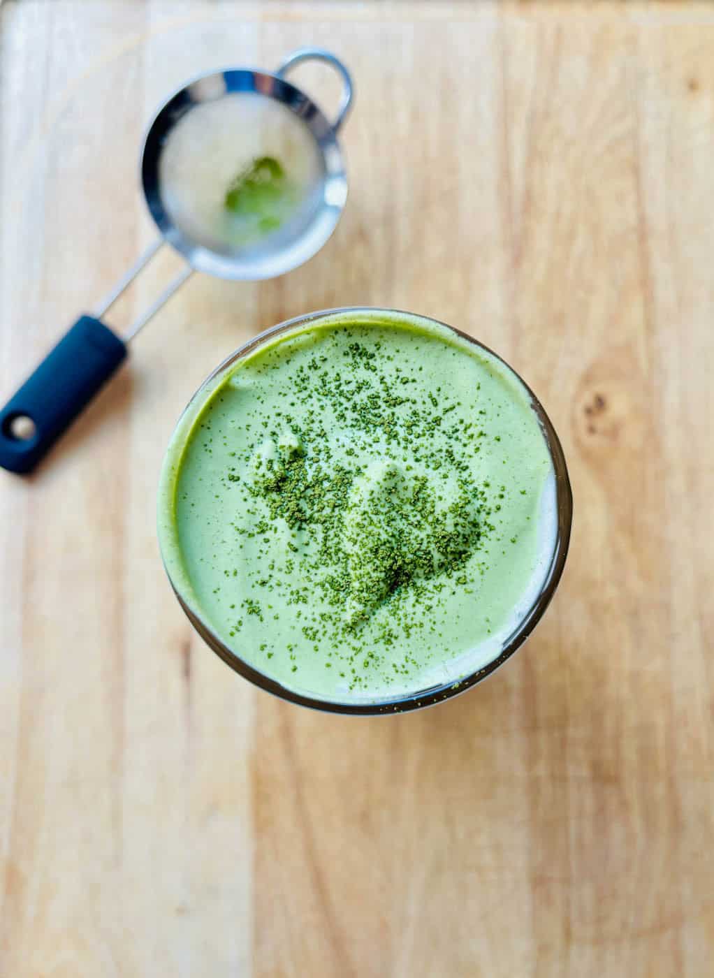 Matcha cold foam dusted with matcha powder.
