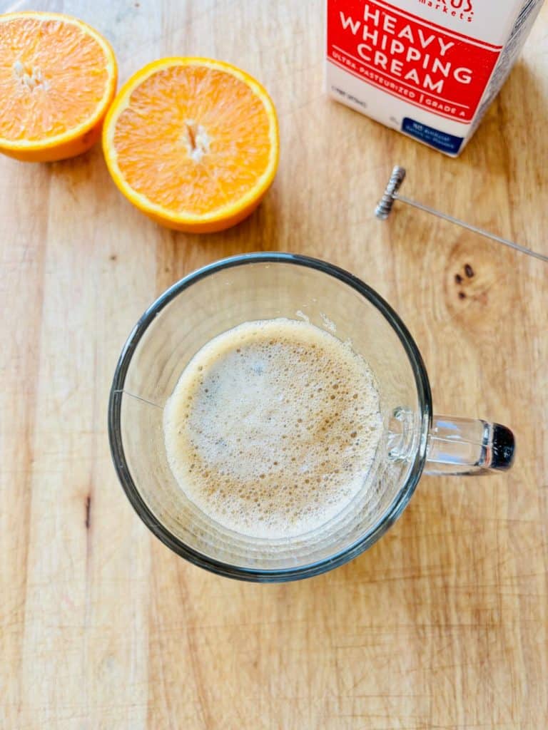Cut oranges, whipping cream, and coffee in a cup.