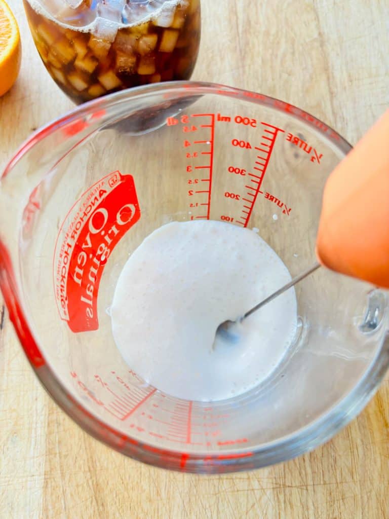 Whipping the cream and sweetener.