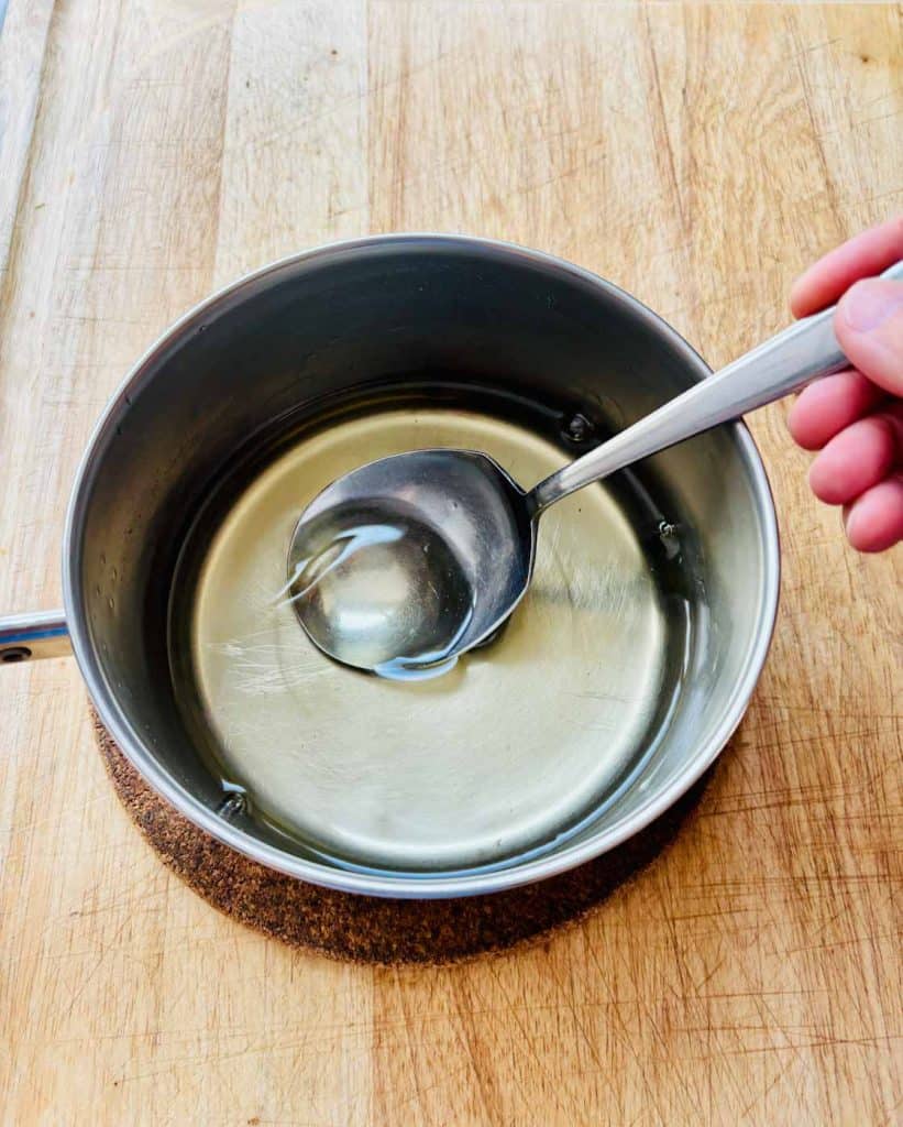 Stirring syrup with a spoon.
