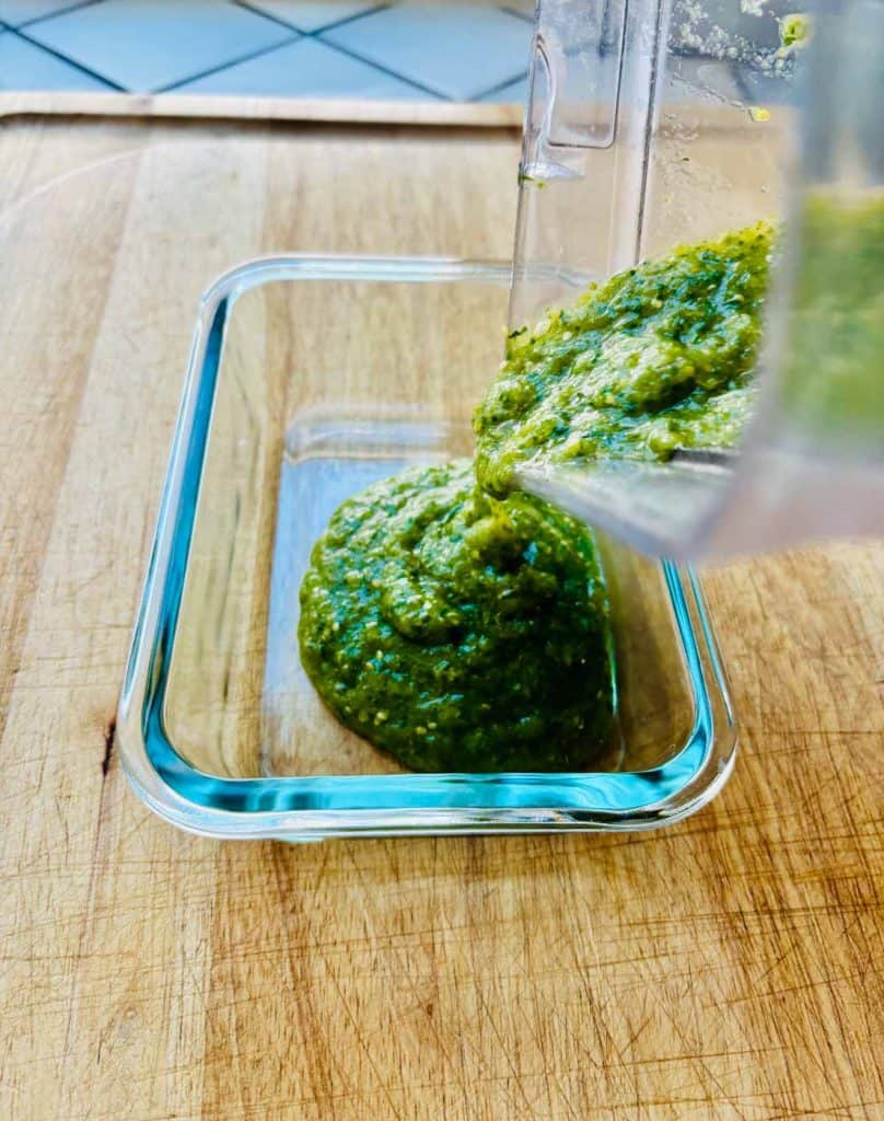 Pouring salsa into a dish.