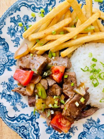 Lomo saltado with rice and French fries.