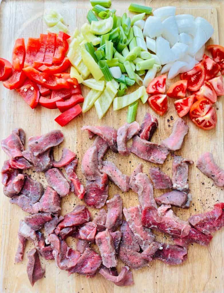 Chopped veggies and sliced meat.